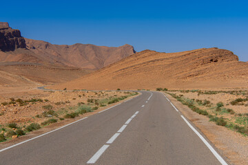 Long road through the Moroccan desert along the Atlas Mountains