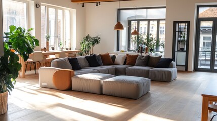 Scandinavian-inspired living room with a large modular sofa, oak floors, and minimalist furniture in a bright, open space