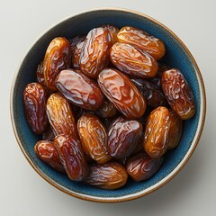 Dates in bowl isolated on white background with shadow. Bowl full of dates top view. bowl with date fruit flat lay. organic, healthy, vegan, vegetarian dates full of vitamins
