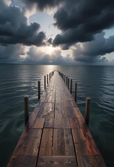 A long wooden pier extends out into the water with dark clouds covering the sky and a sense of...