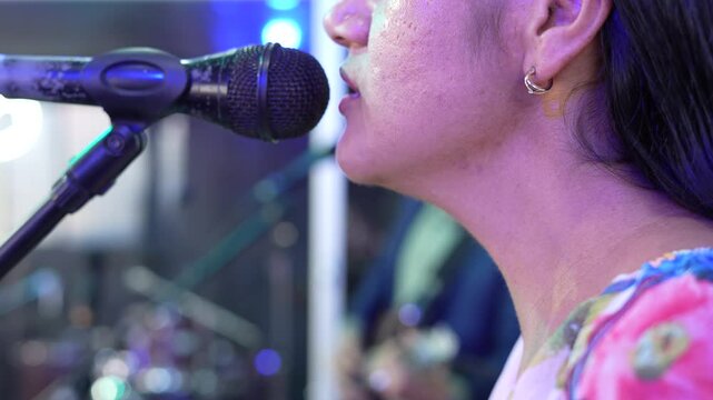 Close-up of a Latin singer's mouth in a music recording studio