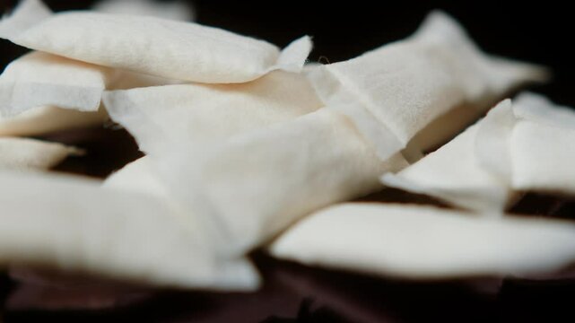 Snus nicotine tobacco close up, pack of tobacco for gum. unhealthy addiction. Man opening box with snus and taking one. 
