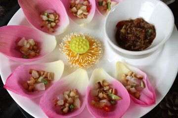 Savoury Sacred Lotus petals Wraps in thai called Miang Kham.Miang Kham sometimes uses the leaves of other types of vegetables as ingredients.