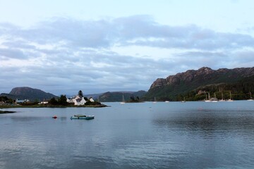 A view of the beautiful  small Scottish highlands town of Plockton, with flowers along the road, along the waters of Loch Carron,in  Scotland, United Kingdom