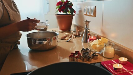 Person preparing dough on a beige countertop for holiday baking