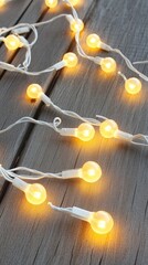 Wooden surface adorned with warm white LED Christmas lights creates a magical atmosphere, perfect for holiday greetings or seasonal design. Ideal for joyful celebrations