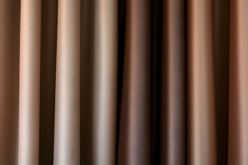 Fototapeta premium Close up texture of in trendy color-mocha mousse silk fabric. Background for design. Macro strokes. 