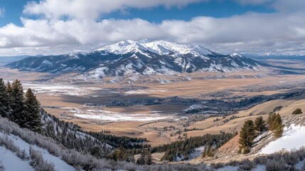 Snow capped mountains overlook valley town winter landscape