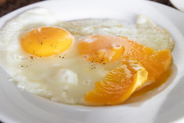 Delicious fried eggs with vibrant orange yolks.