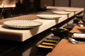 Elegant dining setup with plates and spices.