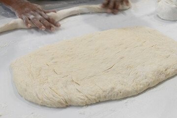 Kneading dough on a clean kitchen surface.