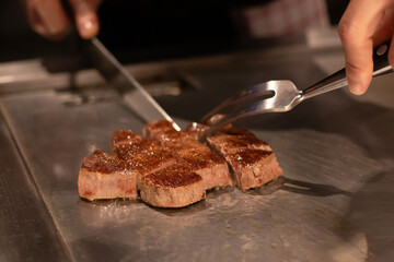 Chef cooking a delicious steak on the grill.