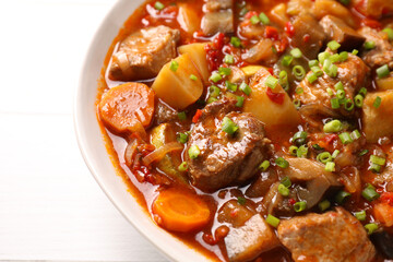 Delicious stew with vegetables in bowl on table, closeup
