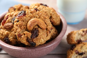 Delicious oatmeal cookies with raisins and nuts on table, closeup
