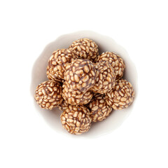 Delicious chocolate puffed rice balls in bowl isolated on white, top view
