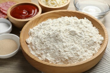 Making calzone pizza. Different ingredients on wooden table, closeup