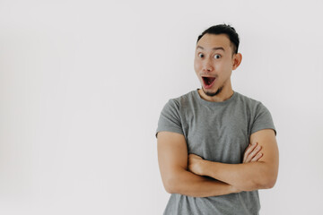 Fototapeta premium Wow and happy face of Asian man in grey t-shirt isolate on white.