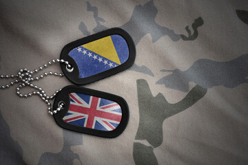 army blank, dog tag with national flag of bosnia and herzegovina and great britain on the khaki...