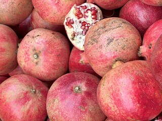 ripe pomegranates, whole and broken, on the counter