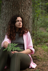 Woman relaxing by tree, harmony