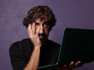 young bearded crazy man with a laptop