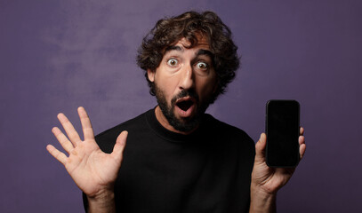 young bearded crazy man with a smartphone