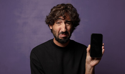 young bearded crazy man with a smartphone