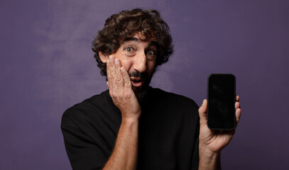 young bearded crazy man with a smartphone
