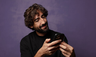 young bearded crazy man with a smartphone
