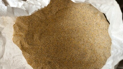 white open top bag with dry mixed feed for farm poultry, combined nutrition from ground grains and food additives for keeping farm animals