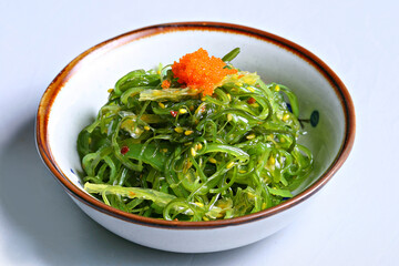 Chuka Wakame, Sharks fin seaweed salad with sesame and ebiko dressing in white background 