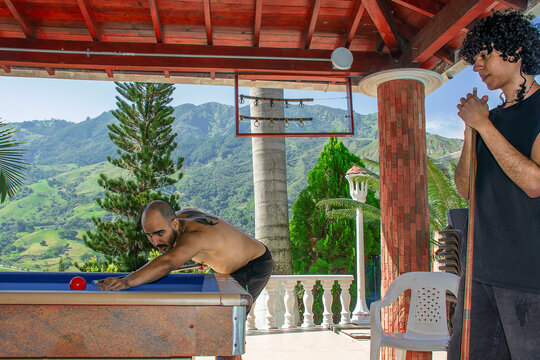 Two young men playing pool