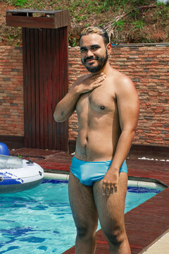 Man in swimsuit smiling ata the camera