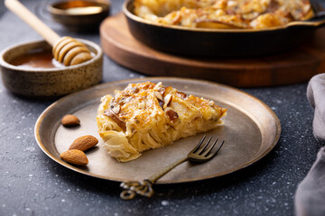 A piece of phyllo pastry pie with pear, gorgonzola cheese, almond and honey
