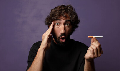young bearded crazy man with a cigarette