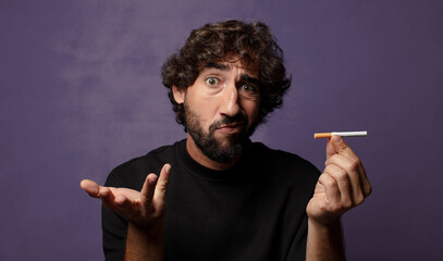 young bearded crazy man with a cigarette