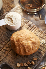 Dough made of whey protein powder, maple syrup and peanut butter - preparation of homemade protein chocolate bars