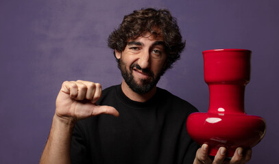 young bearded crazy man with an empty flower pot