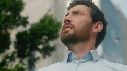 Close up smiling happy Caucasian middle aged adult man thinking looking around male guy business employer businessman manager inspired in city office building sun sky sunny insurance hope religion
