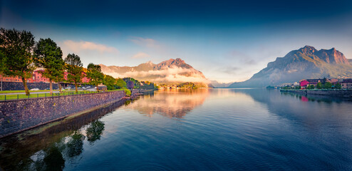 Calm summer view of Como lake in Italian Alps. Majestic morning cityscape of Lecco town with...