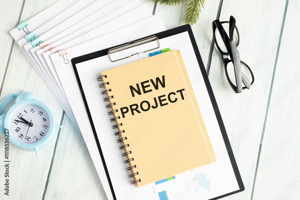 Poster notepad with text new project, next to it lies a calculator. business concept.