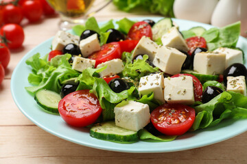Delicious salad with feta cheese served on white wooden table, closeup