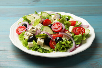 Delicious salad with feta cheese on wooden table, closeup