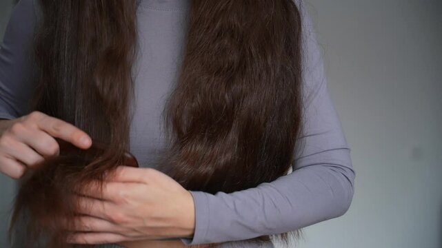 combing long dark hair with a natural wooden comb