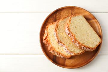 Freshly baked sponge cake on white wooden table, top view. Space for text