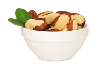 Tasty Brazil nuts and green leaves in bowl isolated on white