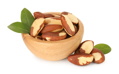 Tasty Brazil nuts in bowl and green leaves isolated on white