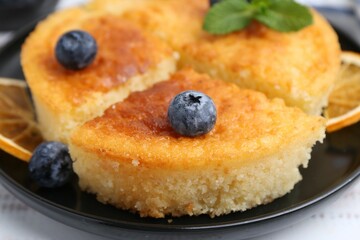 Delicious semolina cake with blueberries on white wooden table, closeup