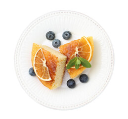 Pieces of delicious semolina cake with blueberries and orange slices isolated on white, top view