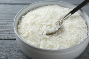 Soy wax in bowl on grey wooden table